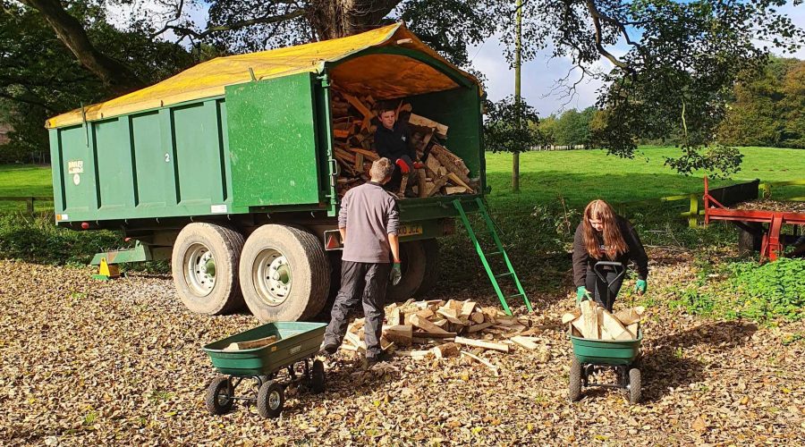 The Saturday club emptying wood from a trailer