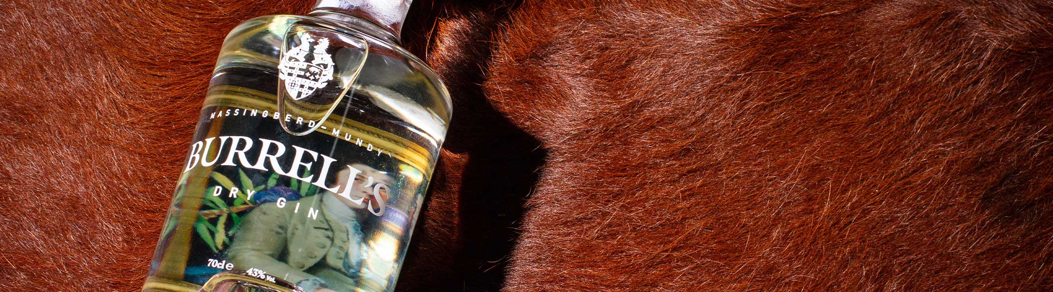 Bottle of Burrell's Dry Gin on red cow skin